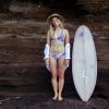 Zealous Bikinioberteil V Signatur Marie neben Surfboard